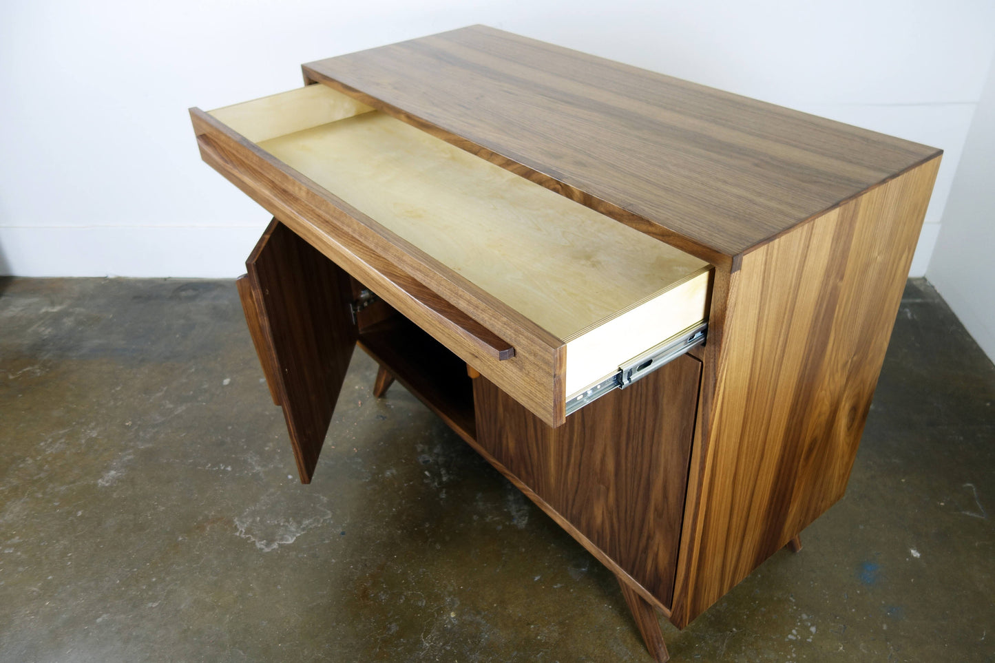 Close-up of the single drawer on the Brick credenza, highlighting its solid walnut construction and smooth operation