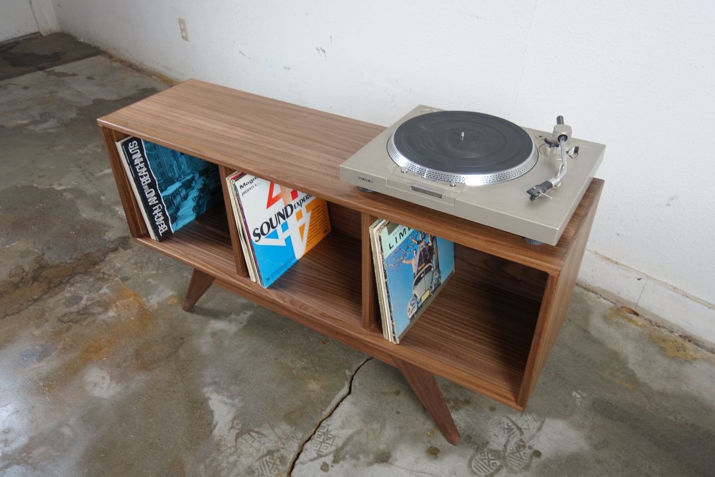 Interior view of the Dabble console’s shelf compartment, perfectly sized for organizing vinyl records in smaller spaces