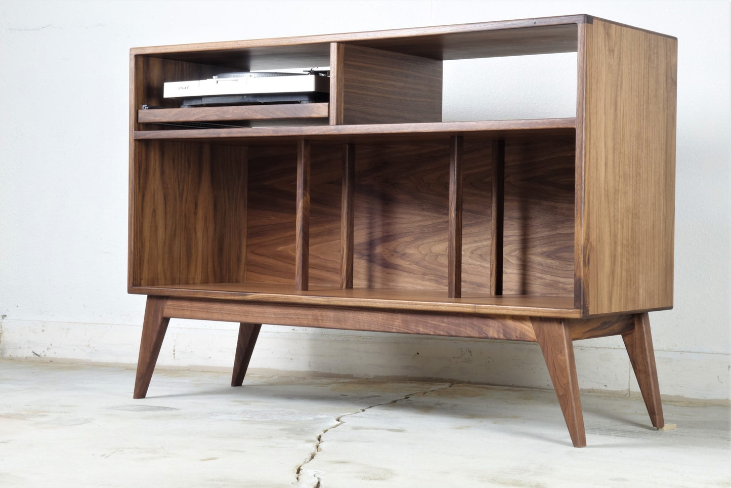 Detailed view of the Felx credenza’s interior compartments, with heights designed to accommodate vinyl records and audio equipment