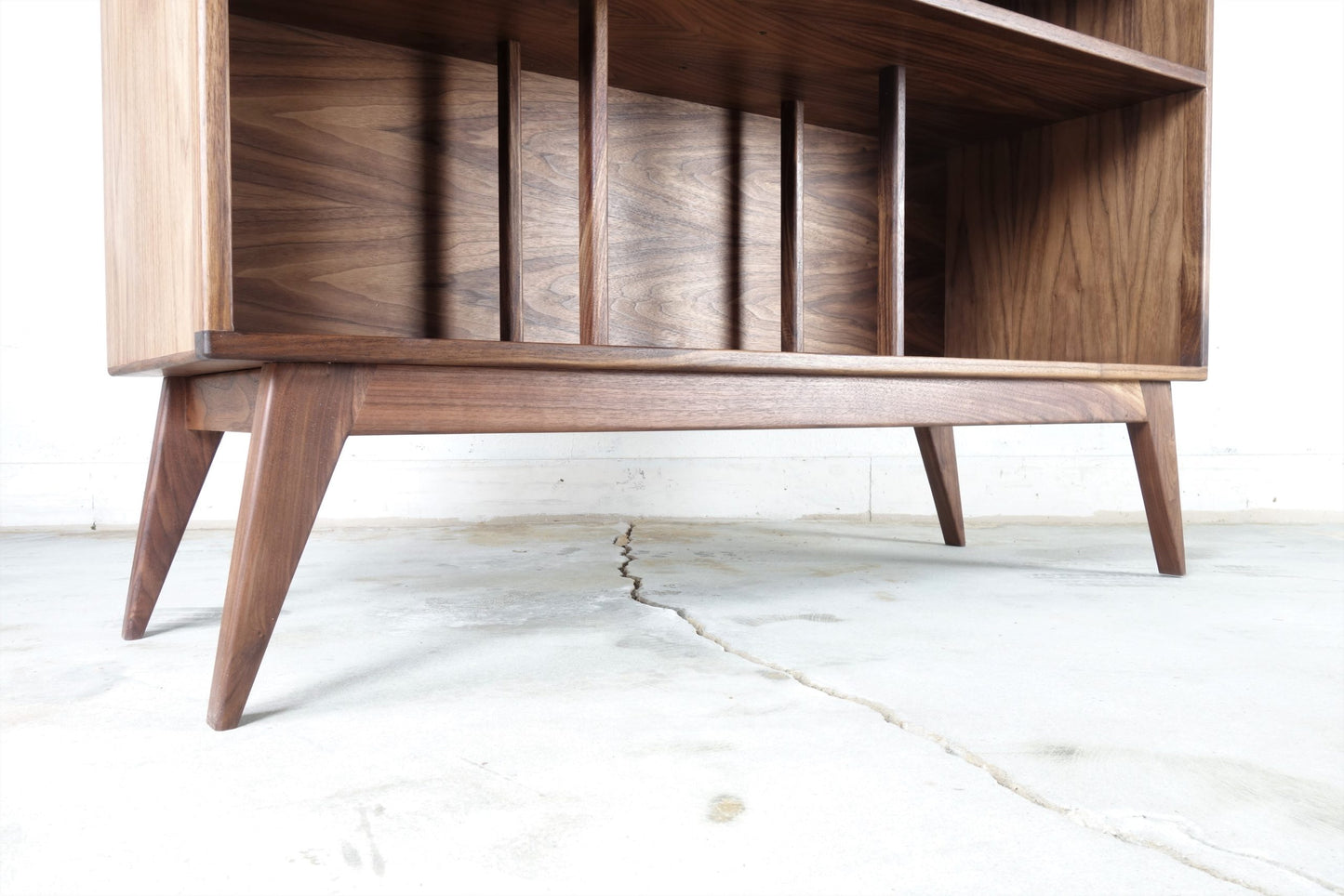 Close-up of the mid-century modern inspired legs on the Felx credenza, angled for stability and style