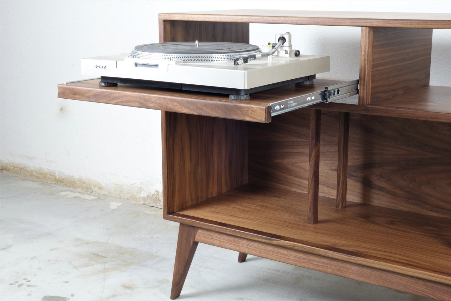 Close-up of the pullout record player shelf in the Felx credenza, designed for easy access to audio equipment