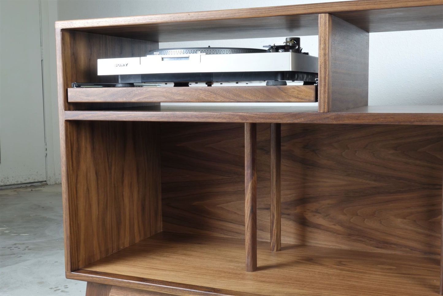 Interior view of the Felx credenza showcasing record storage compartments with dividers, perfect for organizing vinyl records
