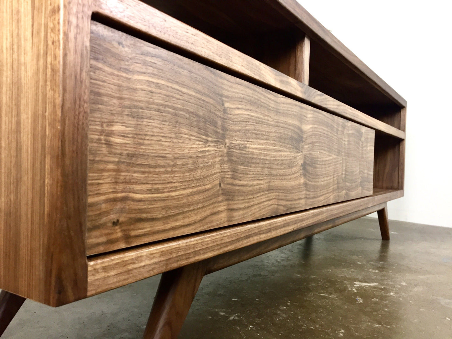 Close-up of the mid-century modern-inspired legs of the PorkChop console, crafted for stability and timeless elegance