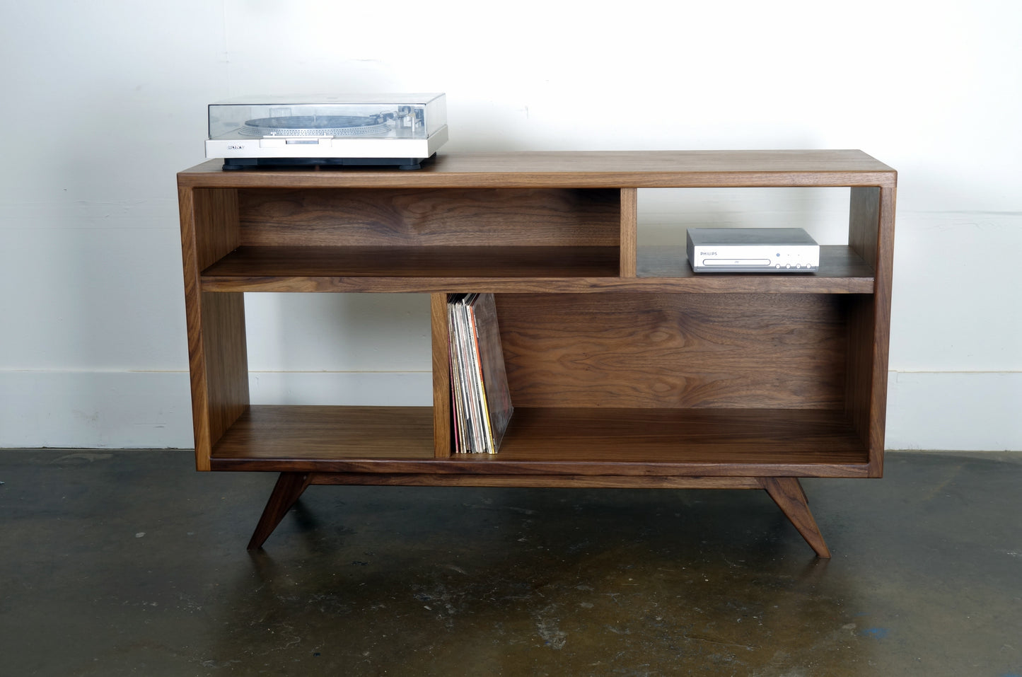 Front-facing view of a handcrafted walnut record storage console, ideal for vinyl display and storage.