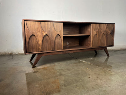 ront view of the mid-century modern Bagel credenza, handcrafted from walnut with sliding doors and timeless design for versatile storage