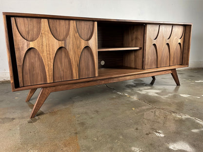 Front view of the Bagel credenza, a handcrafted walnut piece featuring a classically mid-century modern design and sliding doors