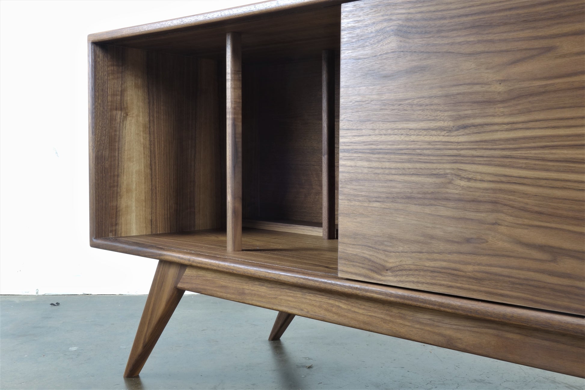 Pullout shelf of the BlackGold credenza, designed for easy access to a record player in a classic mid-century modern style