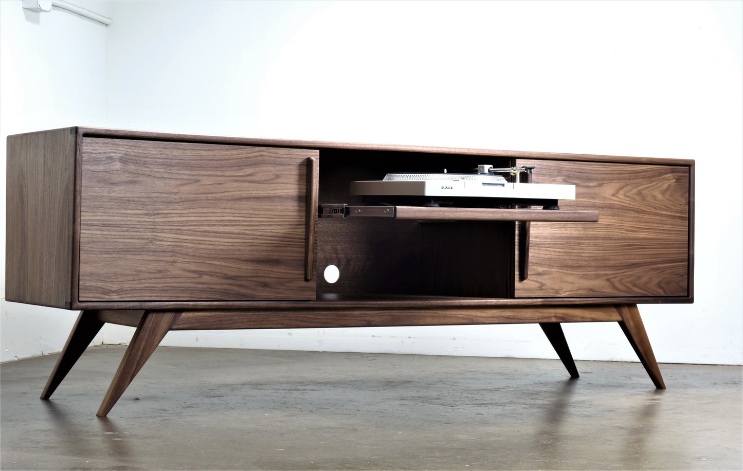 Front view of the BlackGold credenza, a mid-century modern walnut piece designed for record collectors with sliding doors and a pullout shelf