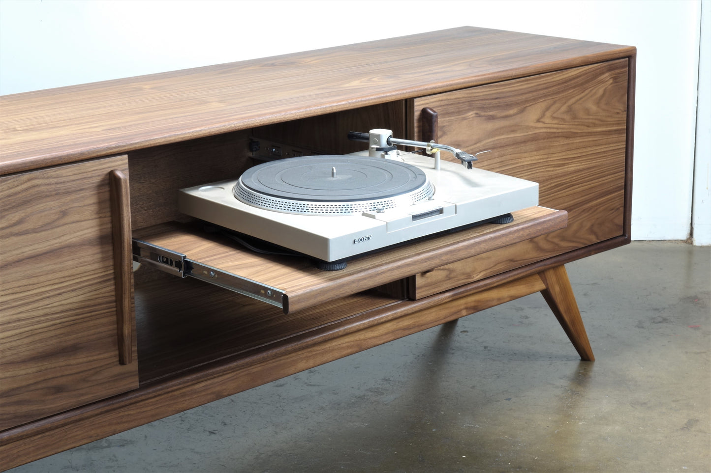 Pullout shelf of the BlackGold credenza, designed for easy access to a record player in a classic mid-century modern style