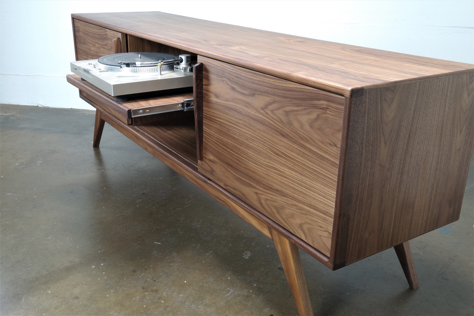 Close-up of the BlackGold credenza’s record storage compartments, featuring dividers for vinyl organization