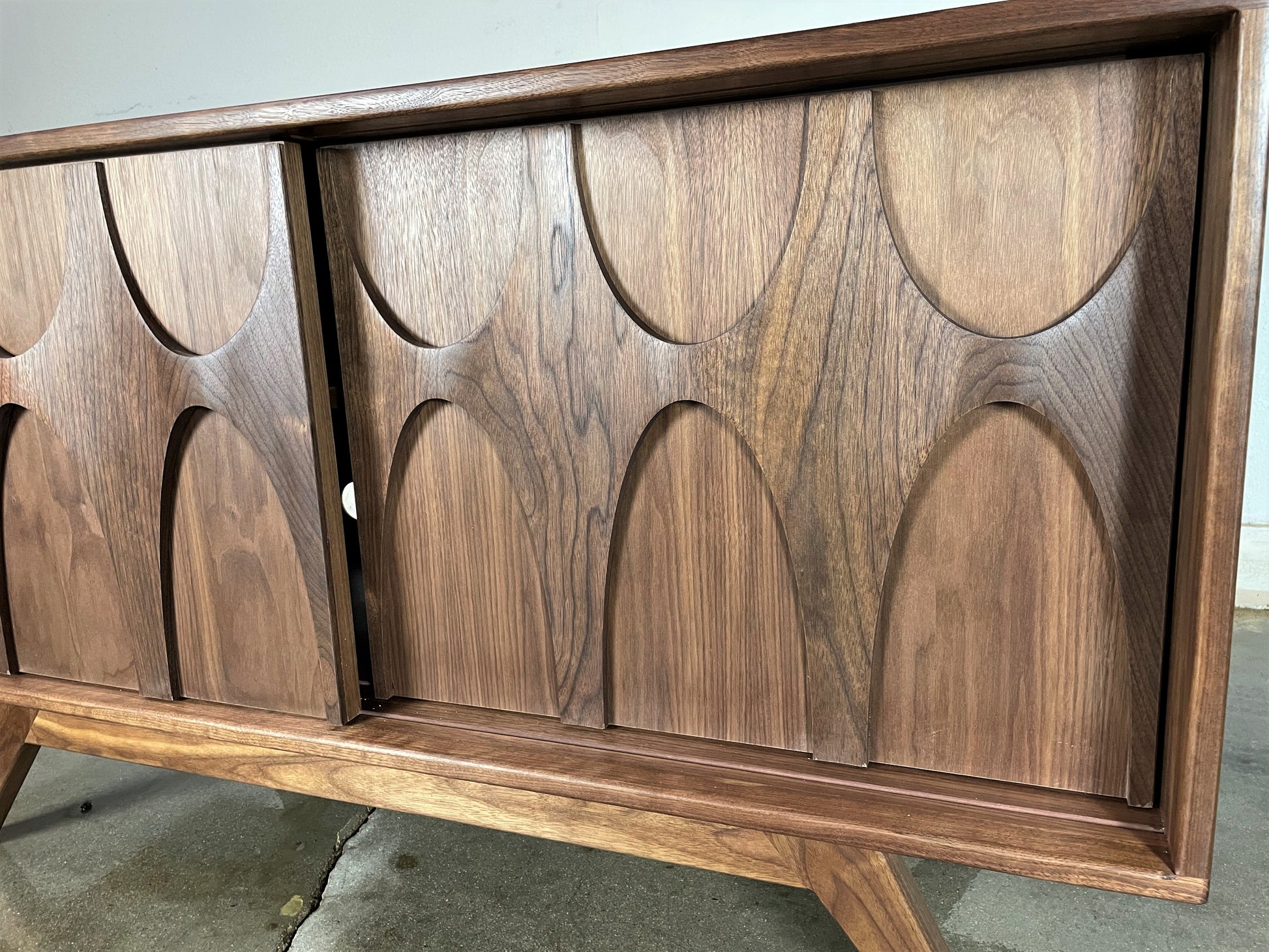 The BRC credenza styled as a centerpiece in a modern living room, combining functional storage with mid-century modern design

