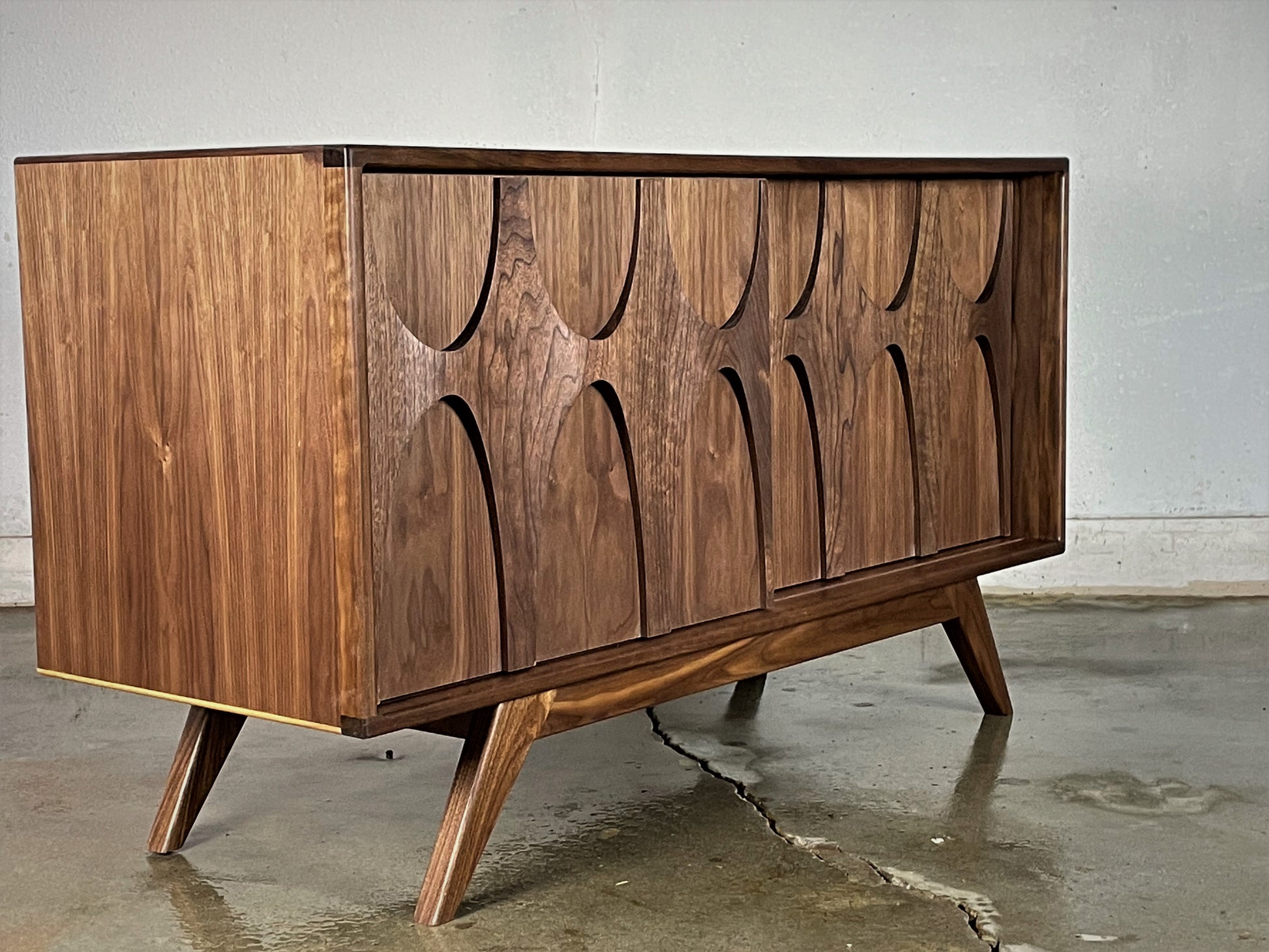 Side view of the BRC credenza showcasing its elegant silhouette and heirloom-quality walnut construction