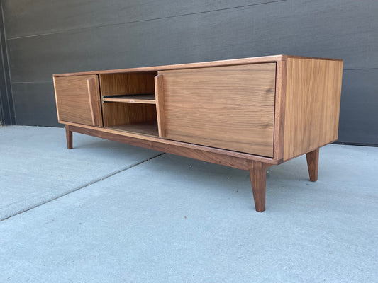 Side profile of the Design One credenza highlighting its sleek mid-century modern silhouette and walnut construction