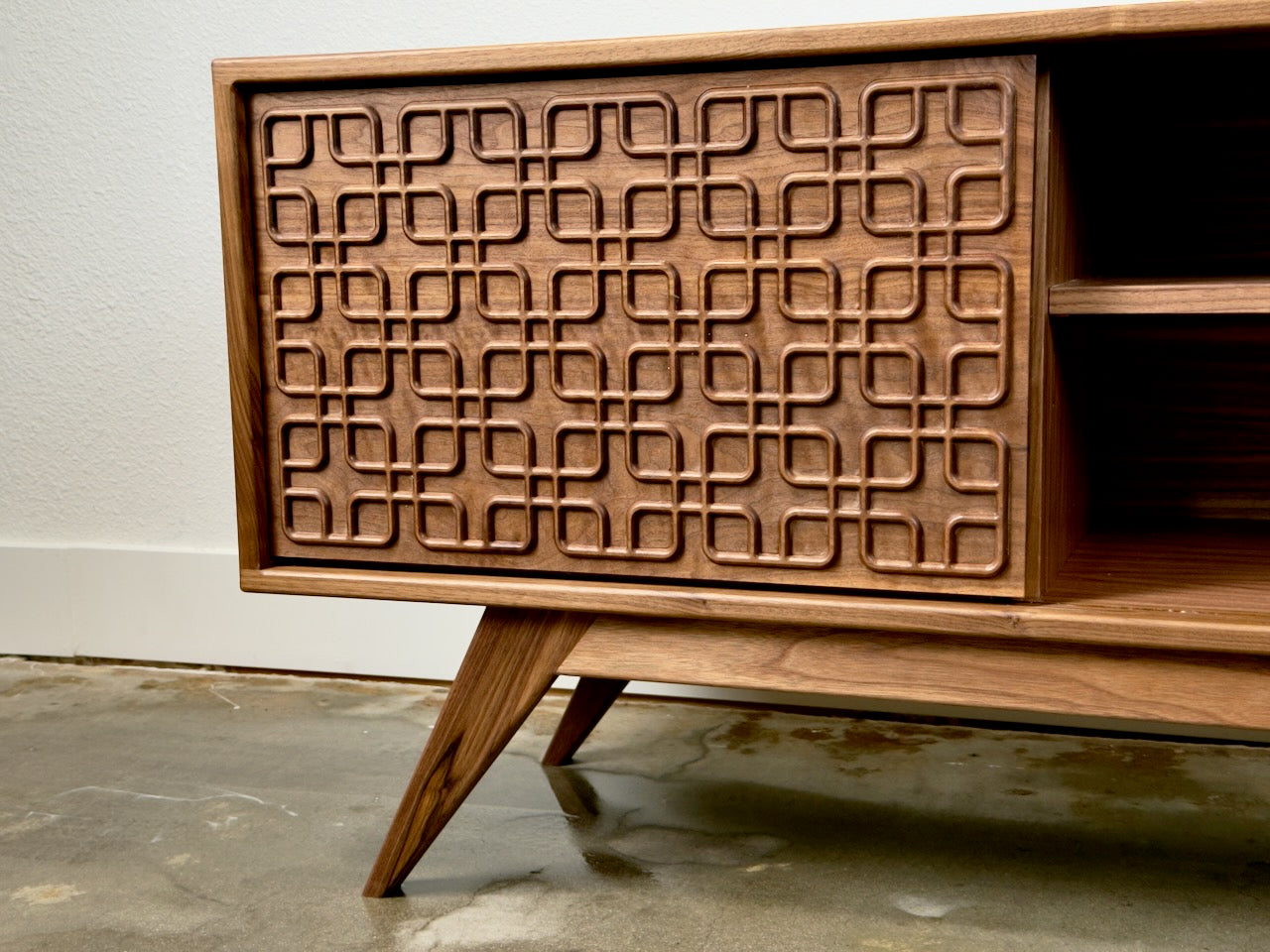 Handcrafted walnut media console detail showing premium wood grain and craftsmanship.