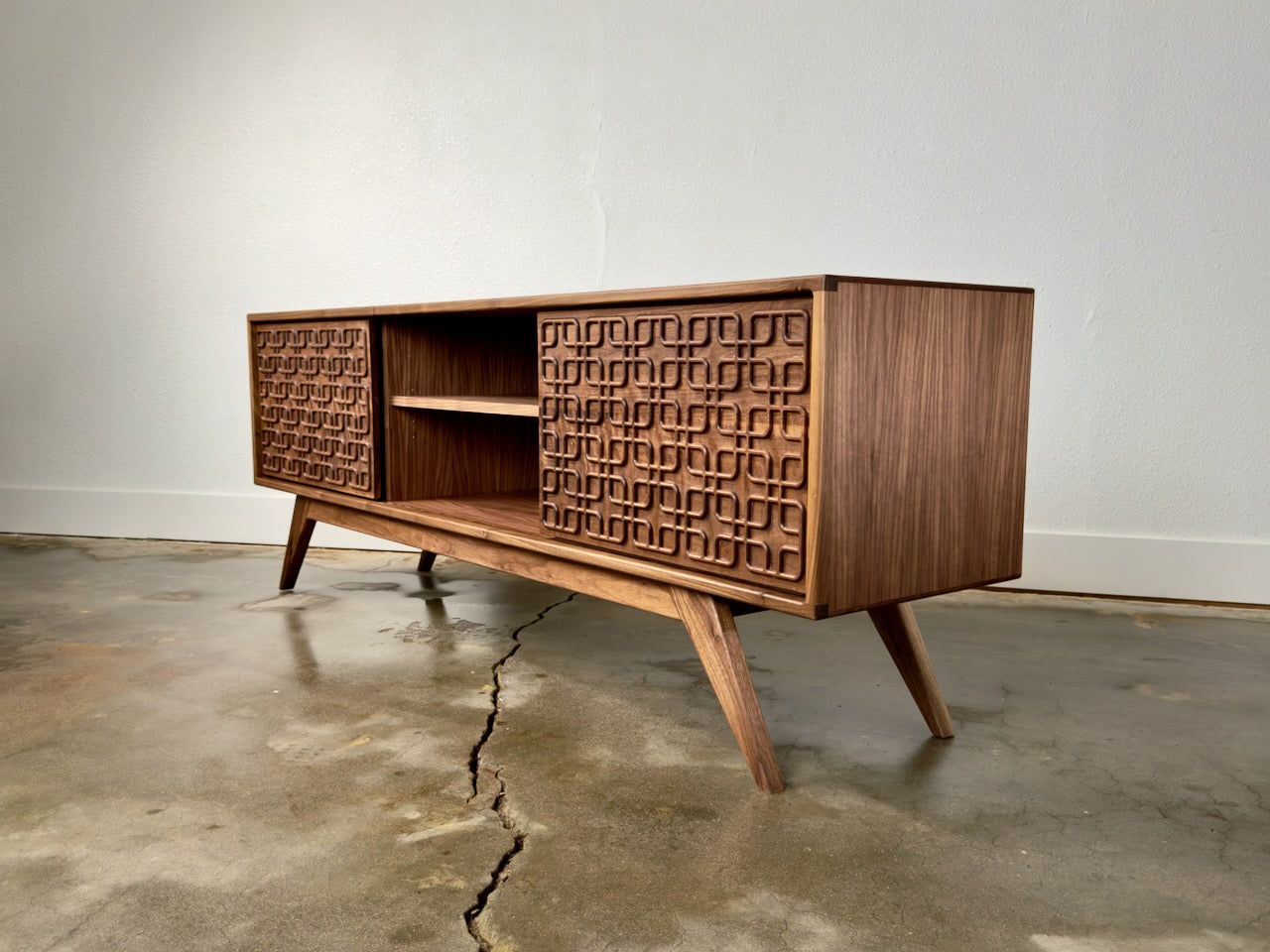 Walnut record player console with storage in a mid century modern style.