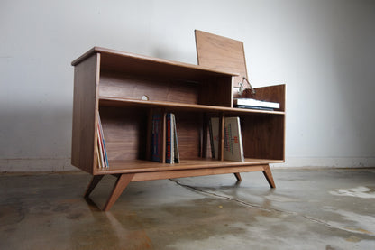 Front view of the Dyno credenza, handcrafted in walnut with a mid-century modern design, flip-up record player top, and record storage dividers