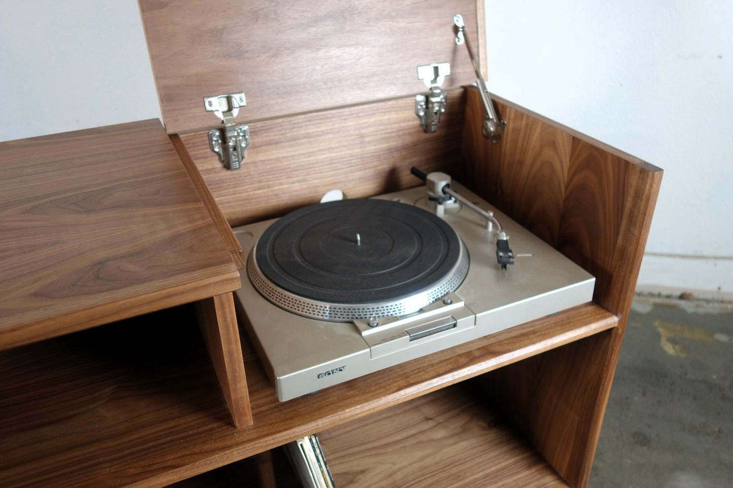 Close-up of the Dyno credenza’s flip-up top, designed for easy access to a record player compartment