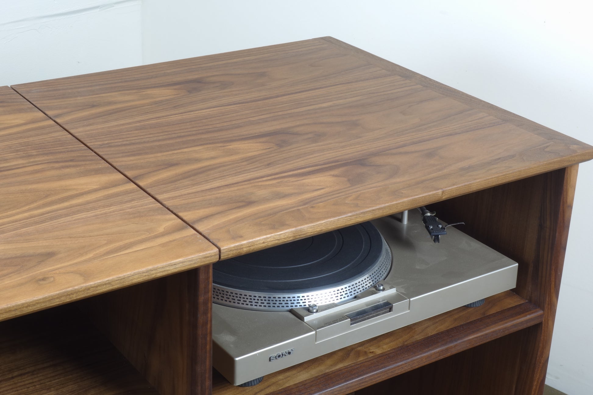 Close-up of the flip-up top on the Electric Koolaide credenza, designed for easy access to the record player compartment