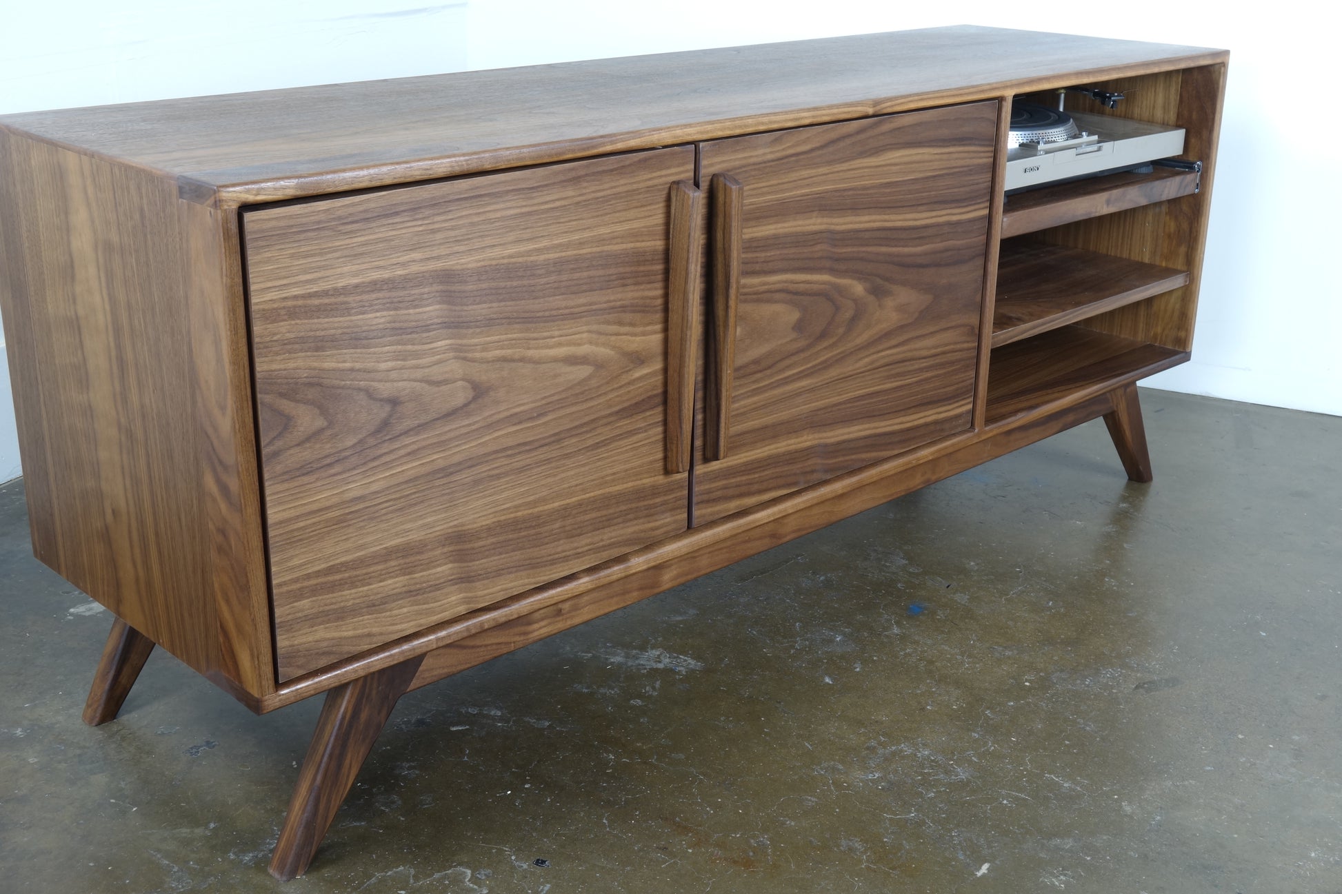 Close-up of the GoldenGirl credenza legs, showcasing a sleek mid-century modern-inspired design for stability and elegance