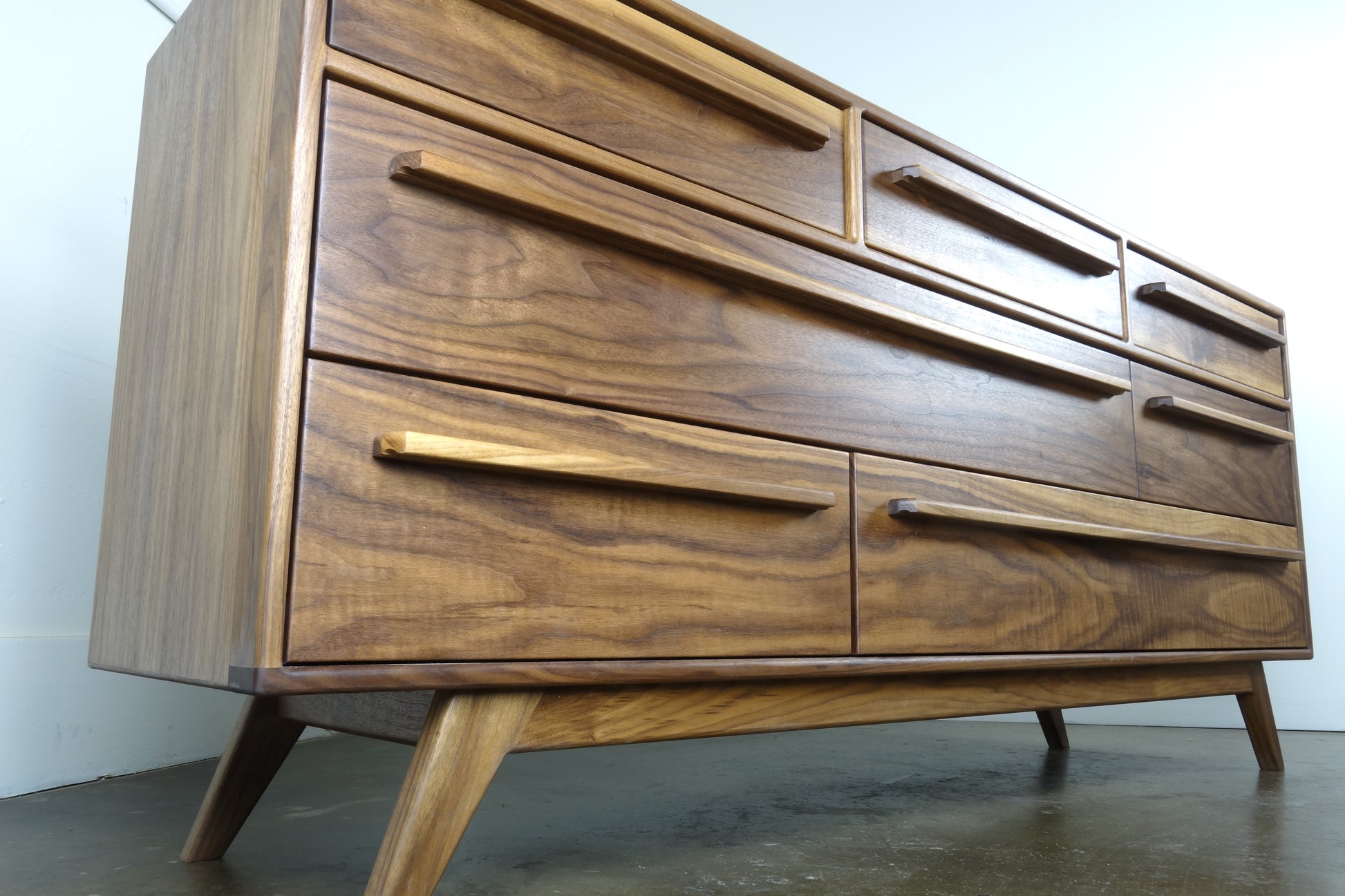 Close-up of the natural walnut wood grain on the JellyBean dresser, highlighting its unique patterns and hand-applied oil and wax finish