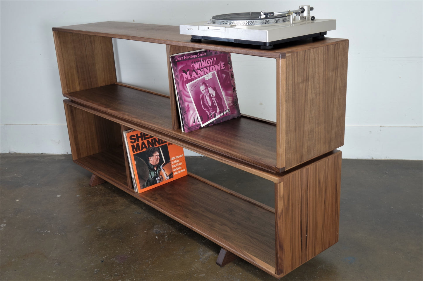 Side view of the JoyFlake console highlighting its clean, minimal design and solid walnut construction