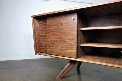 Interior view of the LazyBoy console featuring adjustable shelves with wire access notches for versatile media storage