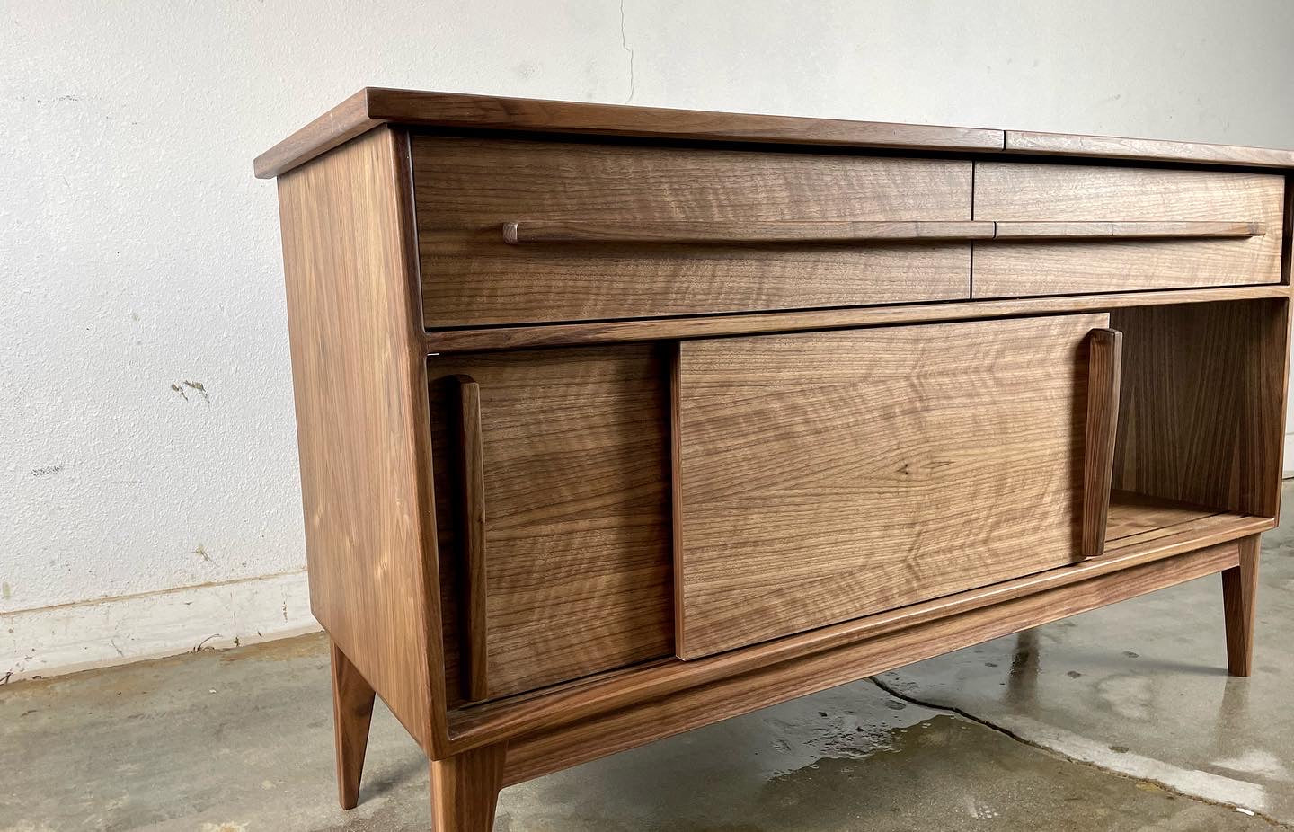 Close-up of the Nanoo credenza’s drawer, providing additional storage space for accessories and media components