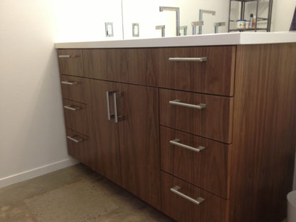 Side view of the single sink vanity highlighting its clean lines, durable wood veneer finish, and functional design