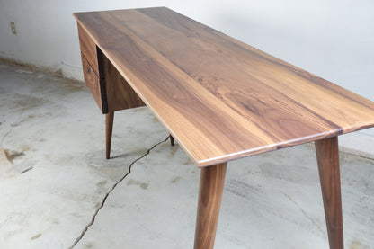 Close-up of the natural walnut wood grain on the SnowCone desk, finished with hand-applied natural oil and wax