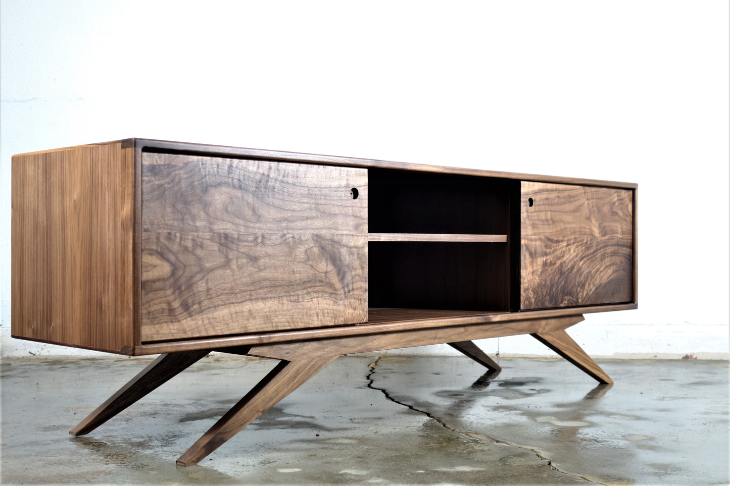 Front view of the Sonic Reducer credenza, hand-built from solid walnut with two sliding wood doors and a classic mid-century modern design