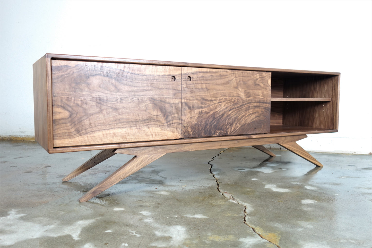 Interior view of the Sonic Reducer credenza featuring three adjustable shelves notched for wire management and versatile storage