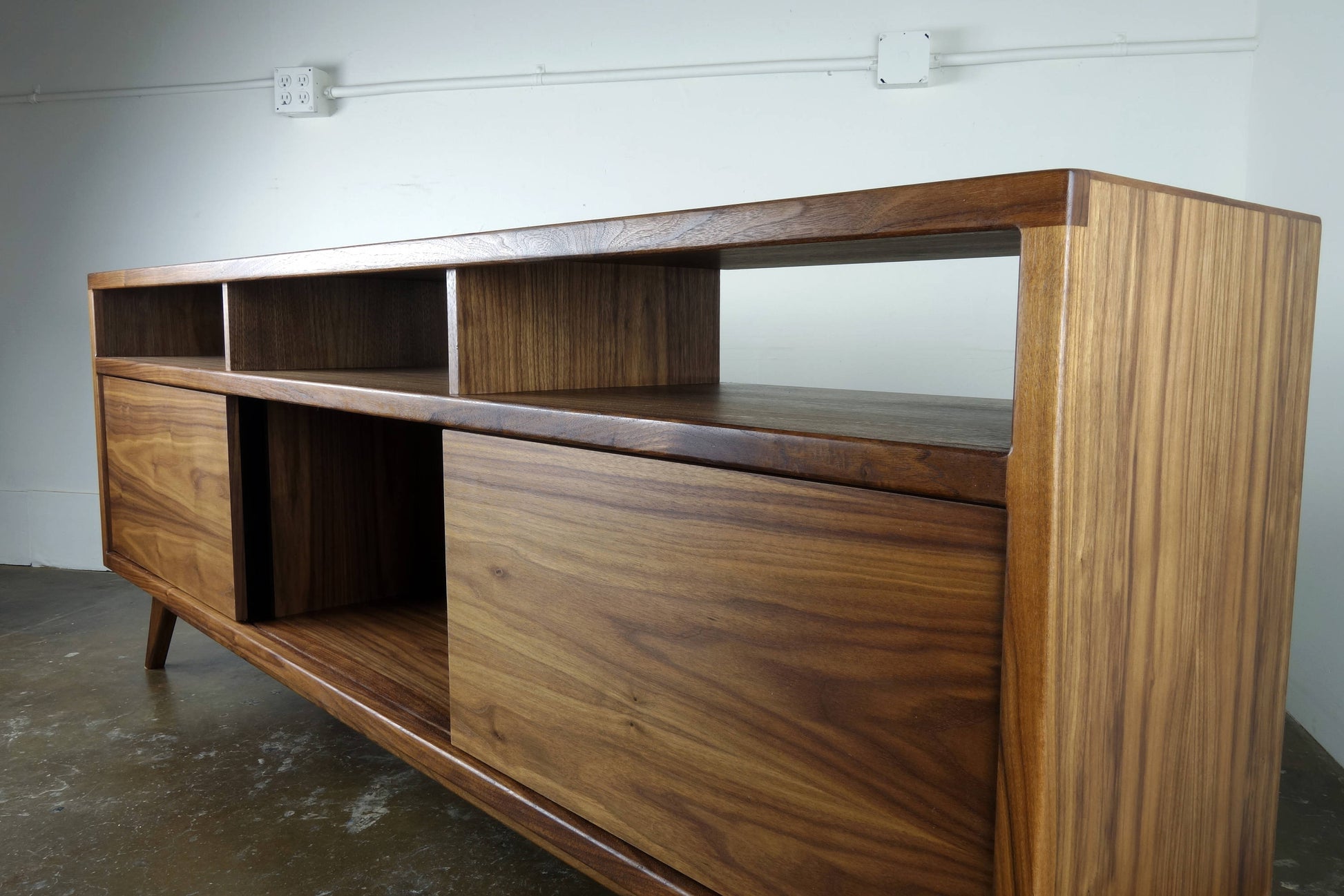 Side view of the SpaceDust console highlighting its clean lines, sleek profile, and timeless mid-century craftsmanship