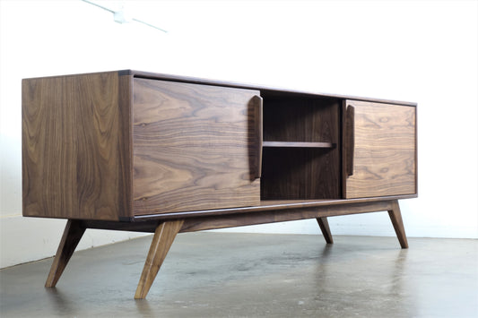 Front view of the StarDust console, hand-built in walnut with two sliding doors and a timeless mid-century modern design