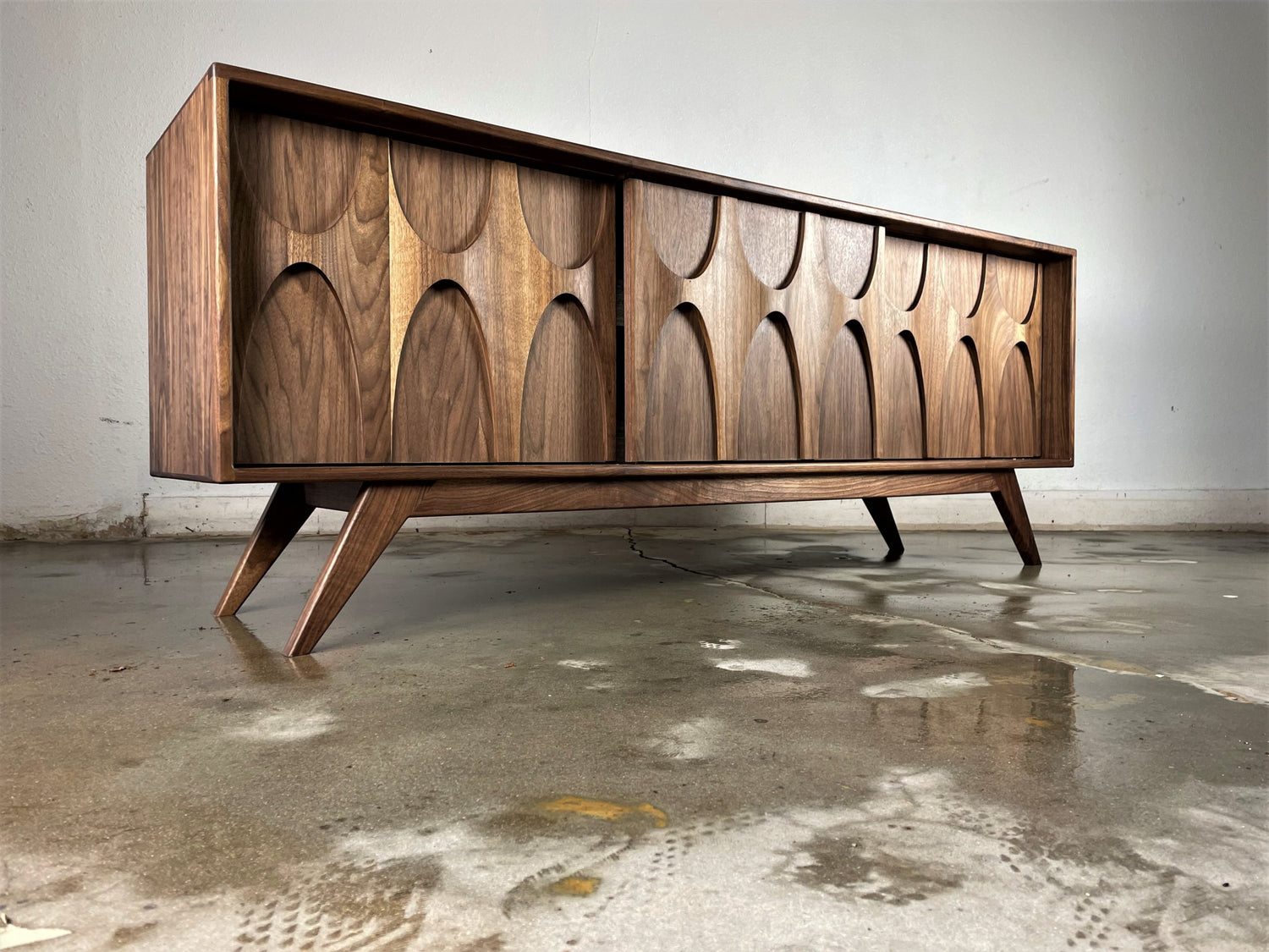 Side view of the Stella-J credenza showcasing its sleek profile, solid wood craftsmanship, and elegant mid-century lines