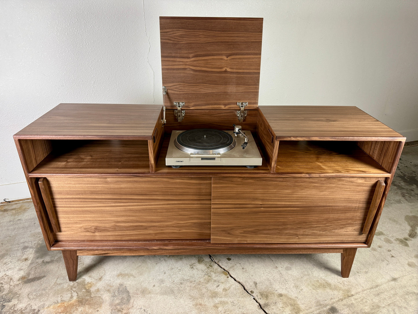 Walnut record player console with flip top lid open showing turntable mid century modern