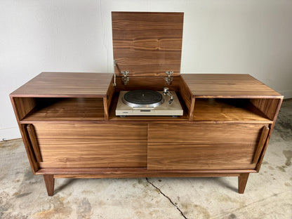 Walnut record player console with flip top lid open showing turntable mid century modern