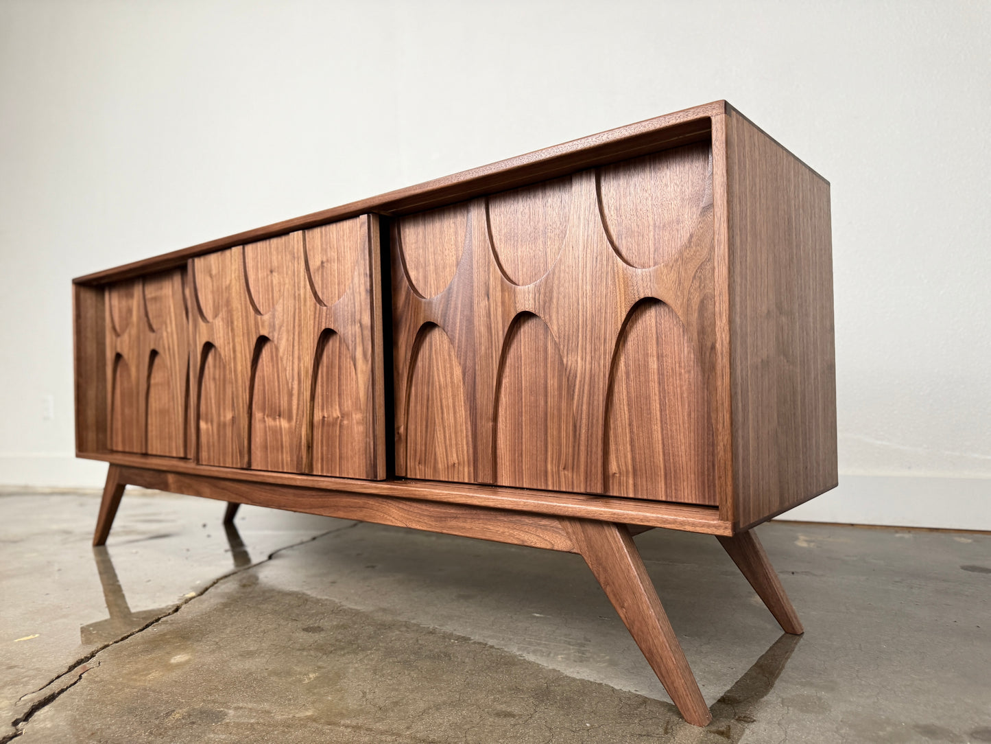 Walnut Stella J console angled view mid century modern sculpted doors