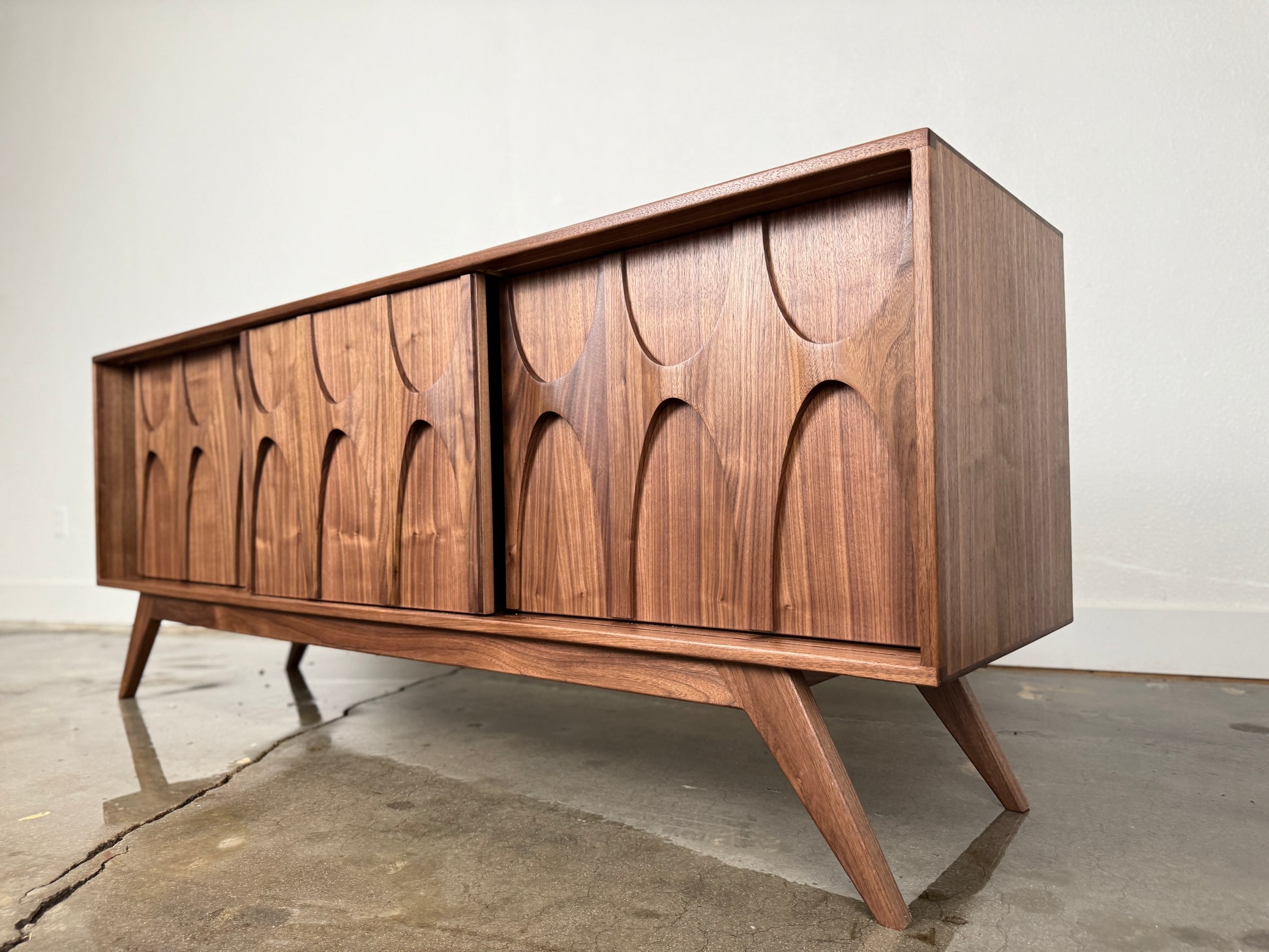 Walnut Stella J console angled view mid century modern sculpted doors