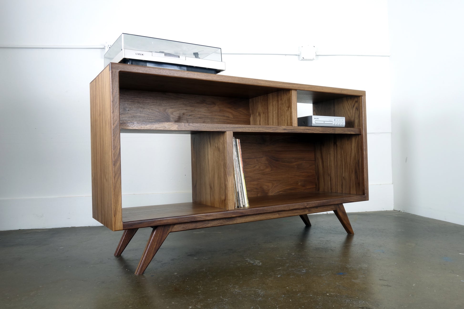 Close-up image of the natural walnut wood grain on the record storage console, showcasing its unique and beautiful patterns."